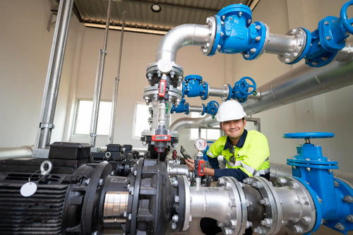 Technician checking water pump and gauges for pump curve analysis