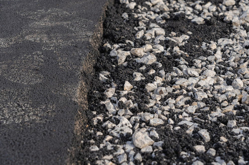 Old asphalt being reused in new road surface 