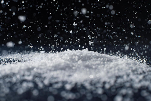 Salt crystals breaking ice surface apart