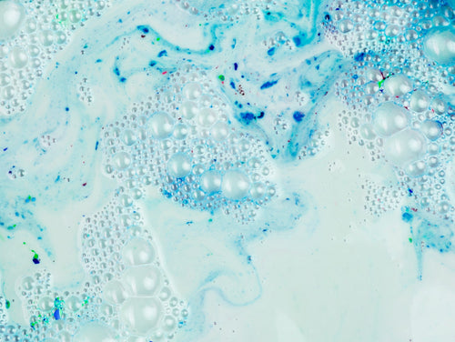 Blue chemical concentrate forming bubbles during reaction